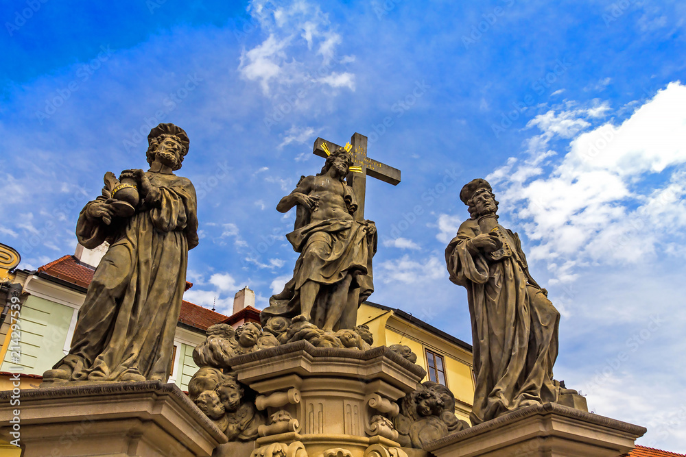 Sculpture of Holy Savior with Cosmas and Damian on the Charles Bridge in Prague. Czech Republic.
