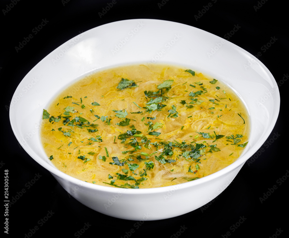 Vegetable soup, broth with noodles, herbs, parsley and vegetables in bowl, isolated on black background, healthy food. Top view. Vegetable soup, broth with noodles, herbs, parsley and vegetables in bowl, isolated on black background, healthy food. Top view.