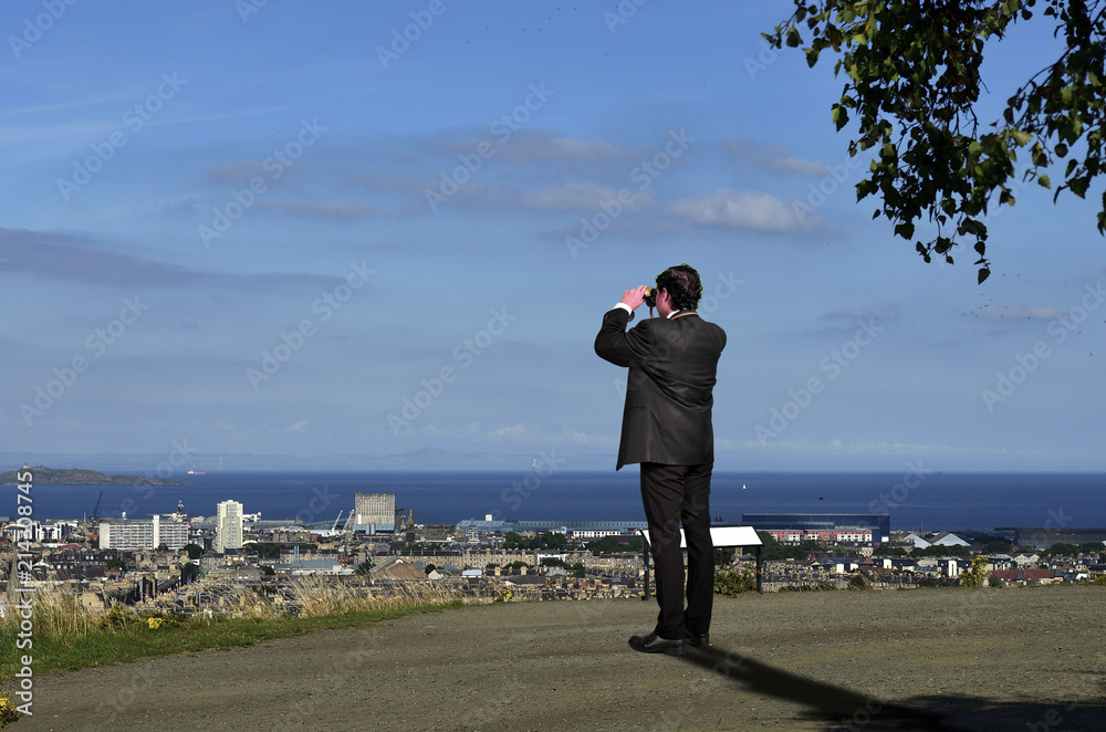 Business Man is spying with Binoculars on Competitors Business Man is spying with Binoculars on Competitors