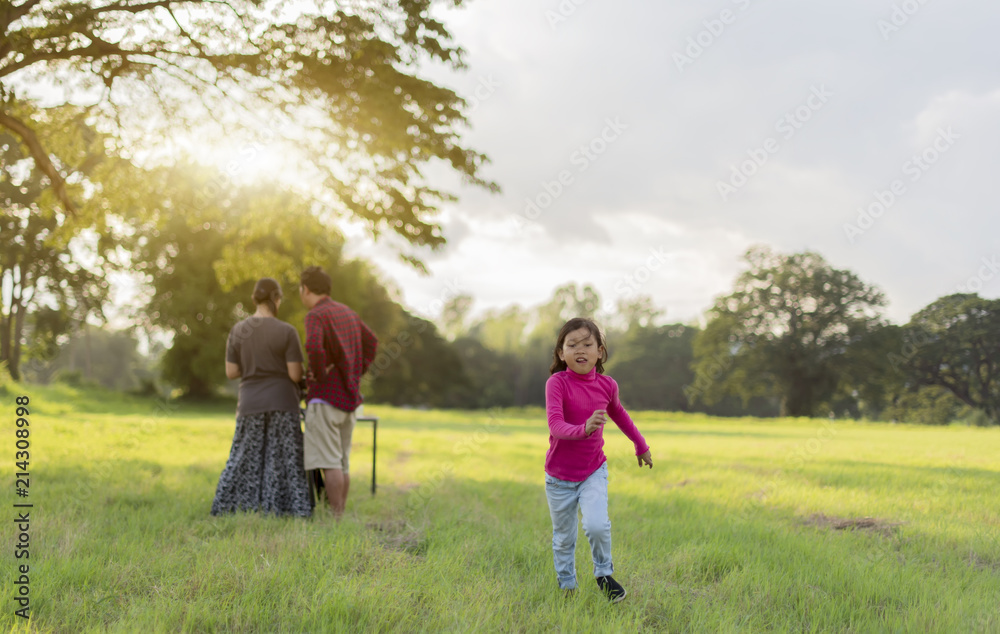 Fototapeta premium a little girl sad with her parents are arguing; Attractive little asia girl is looking angry away crossed eyes looking unhappy while playing in the garden.