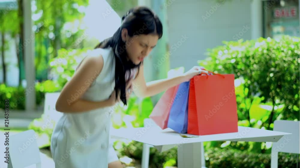 Young woman having heart attack at the garden of mall