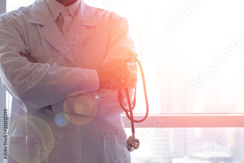 Professional medical physician doctor in white uniform gown coat hand holding stethoscope in clinic hospital.Medical/ healthcare/ technology concept photo
