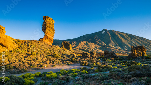 фотографія View of unique Roques de Garcia unique rock formation with famous Pico del Teide mountain volcano summit in the background on a sunny morning