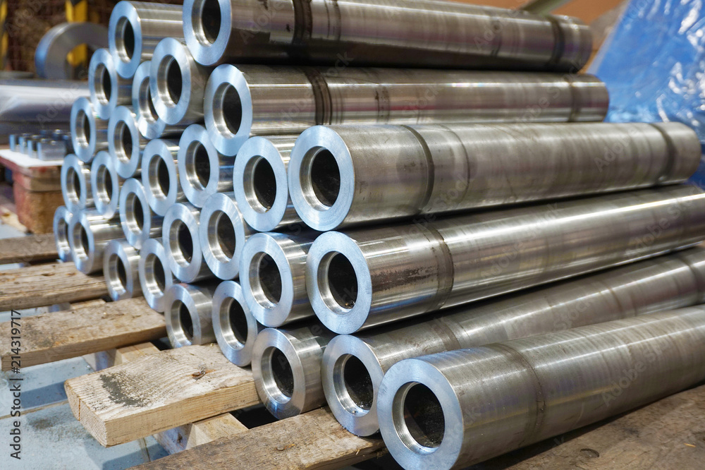 Round cylindrical iron parts after turning are in the warehouse at the factory. Round cylindrical iron parts after turning are in the warehouse at the factory.