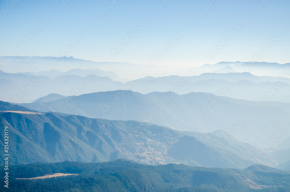 Landscape of mountains range with morning fog.