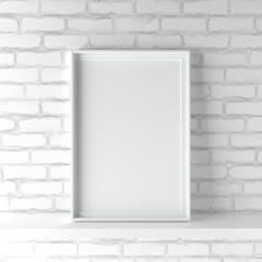 Minimalistic portrait picture frame standing on white painted brick wall