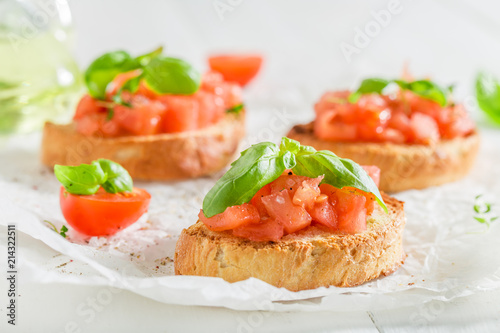Closeup of homemade bruschetta with tomato and basil