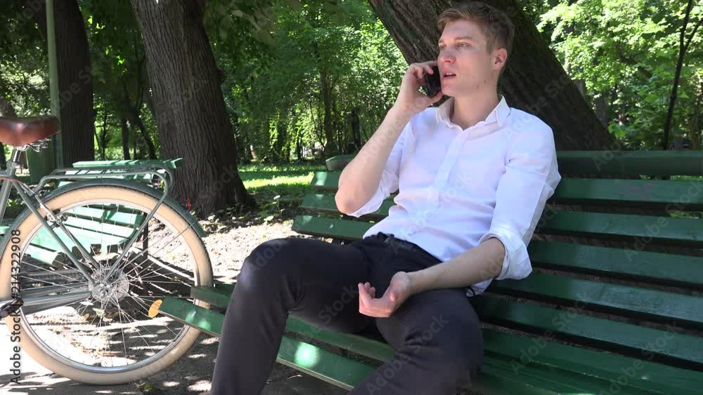 Enjoy relaxing in the park biker modern entrepreneur man mobile phone call talk Enjoy relaxing in the park biker modern entrepreneur man mobile phone call talk