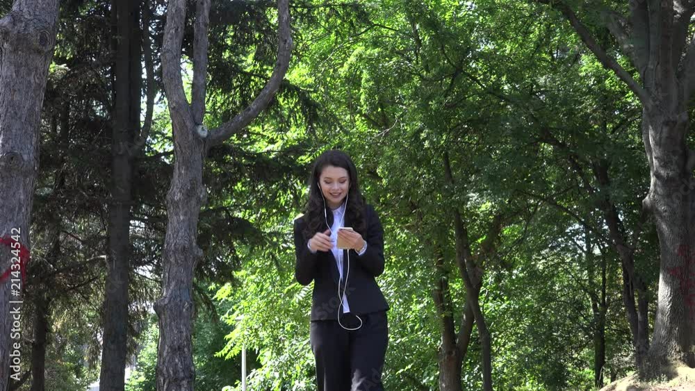 Walking in the park professional confident manager business woman listen music Walking in the park professional confident manager business woman listen music
