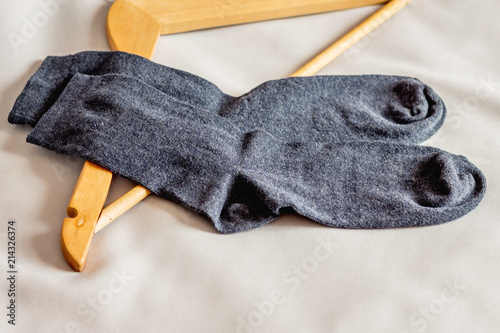 Men's socks near the clothes hanger in the bedroom_