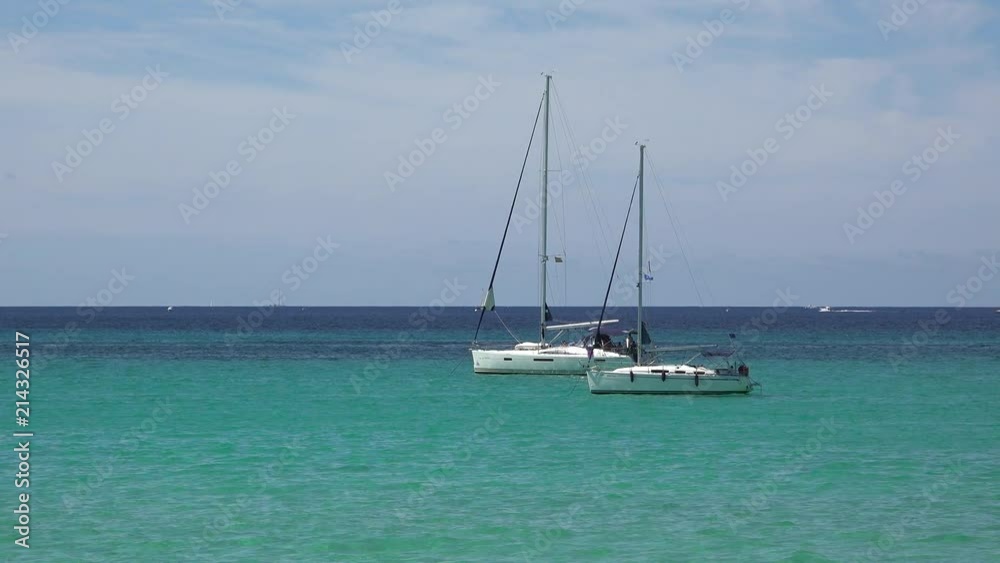 Two white boats floating on turquoise sea water Two white boats floating on turquoise sea water