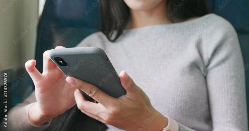 Woman use of cellphone on train Woman use of cellphone on train