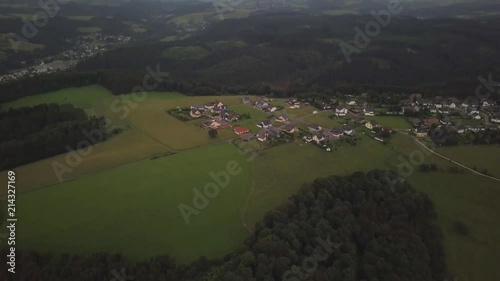  A breathtaking view from the sky to a small settlement of Schleiden in Germany Europe. Local architecture and boundless fields and forests