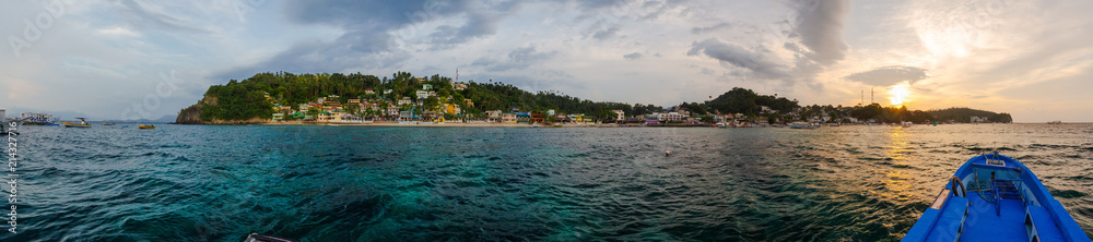 Sunset panorama of Puerto Galera touristic beach, in Sabang, Mindoro, Philippines.