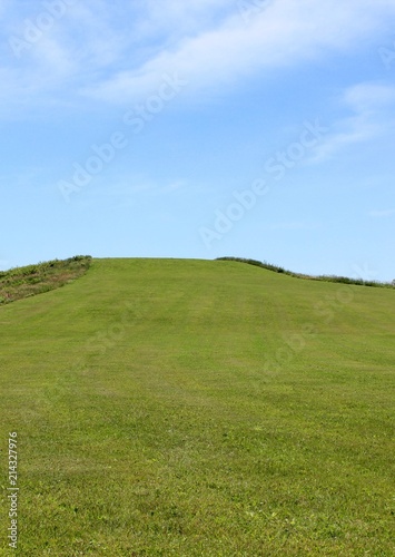 A view of the bright green grass hill landscape.