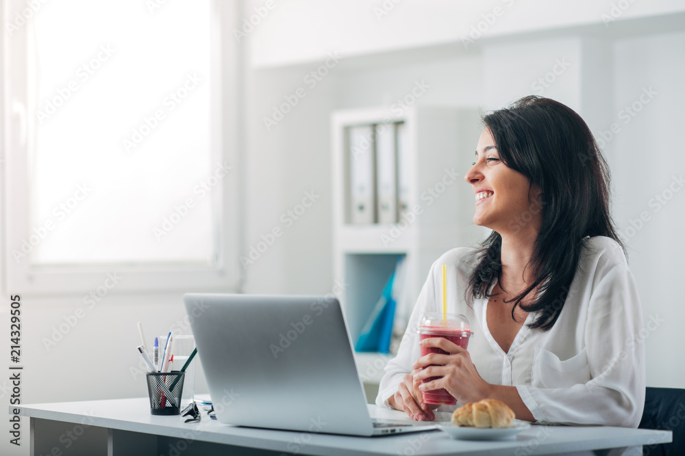 Attractive Woman Drinking Smoothie at the Office Attractive Woman Drinking Smoothie at the Office