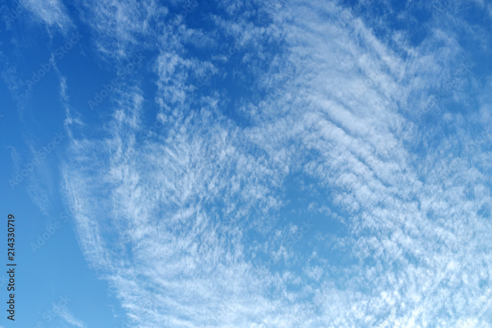 White fluffy clouds in the vast blue sky. Abstract nature background. White fluffy clouds in the vast blue sky. Abstract nature background.