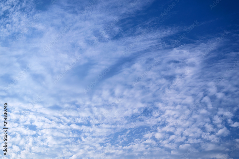 White clouds in the vast blue sky. Abstract nature background.