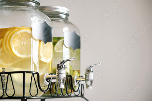 Fresh citrus lemonade with lemons and limes in beverage dispenser