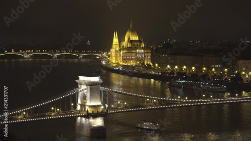 Hungarian Parliament and Sz├⌐chenyi Chain Bridge over Danube river in Budapest photo