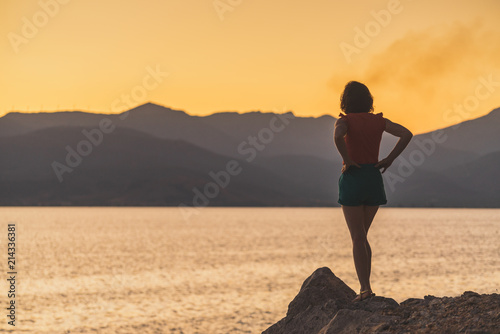 Woman relaxing on coastline
