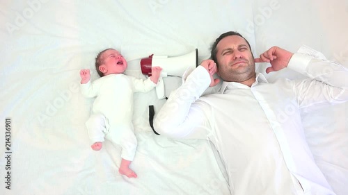 Baby crying on megaphone, father covering ears, conceptual, family reality run, funny rest photo