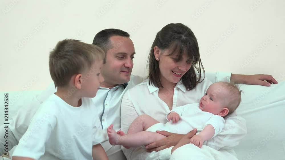 Mother holding baby and father holding big brother, family enjoy new member Mother holding baby and father holding big brother, family enjoy new member