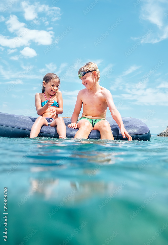 Sister and brother, have fun when swim on inflatable mattress in the sea. Careless childhood time Sister and brother, have fun when swim on inflatable mattress in the sea. Careless childhood time