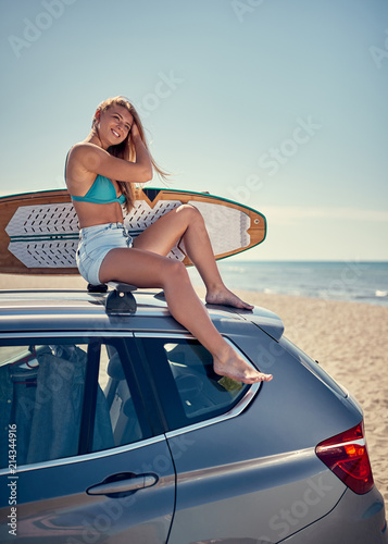Sexy girl waiting for the high waves on beach - Sporty people with surf boards on the beach concept. .