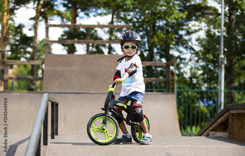 Fototapeta premium Happy boy on a runo with glasses, helmet and protective gear