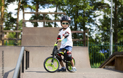 Happy boy on a runo with glasses, helmet and protective gear