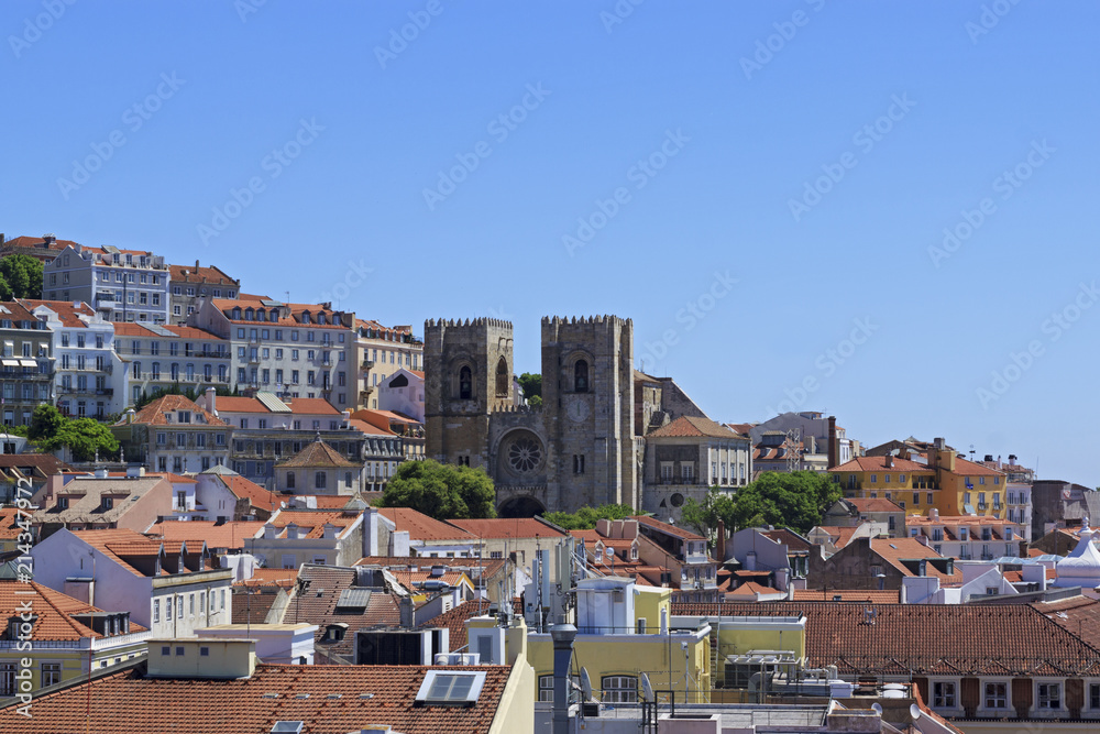 The view of the city from view point. The roofs of the houses.  The Lisbon Cathedral Santa Maria Maior de Lisboa or Se de Lisboa. Portugal.