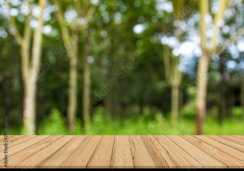 Wood plank with abstract rubber plantation blurred background for product display