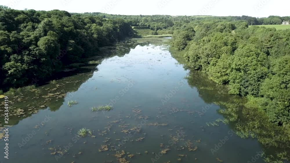 Aerial drone view of beautiful lakes and an old arched bridge spanning the water Aerial drone view of beautiful lakes and an old arched bridge spanning the water