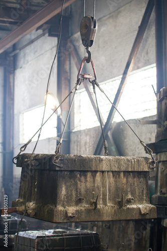 Concrete block hanging on a hook on the industrial production
