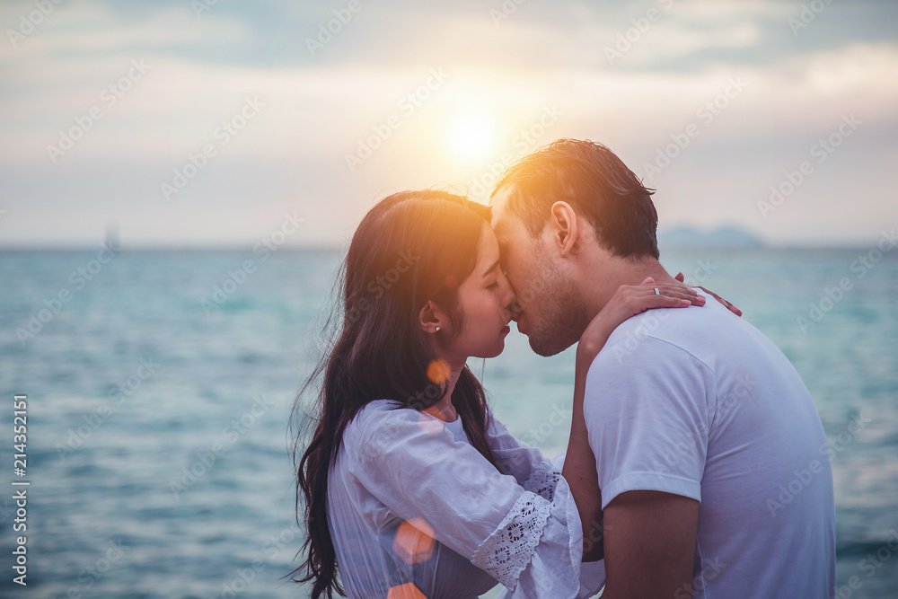 Couple kissing on the beach with a beautiful sunset in background. Couple kissing on the beach with a beautiful sunset in background.