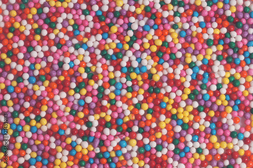 Colorful bright background of small balls for screen saver for designer. Multicolored painted grains. Ball Pool Pattern photo