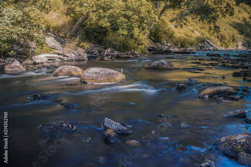 Keila River flowing between rocks in the forest