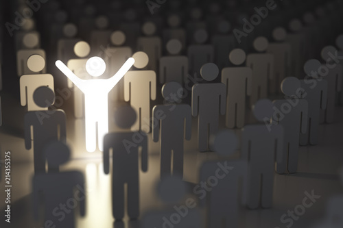 Stand out from the crowd, difference and leadership concept. Many people and a one glowing. photo