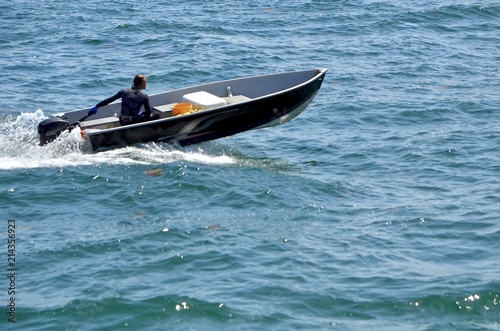 Small black aluminum motor boat primarily used for fishing. © Wimbledon