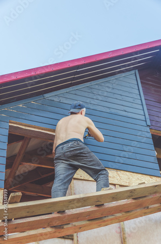 wooden house to paint the worker at height