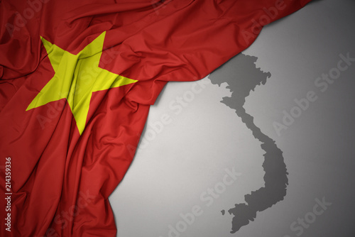 Canvas Print waving colorful national flag and map of vietnam.