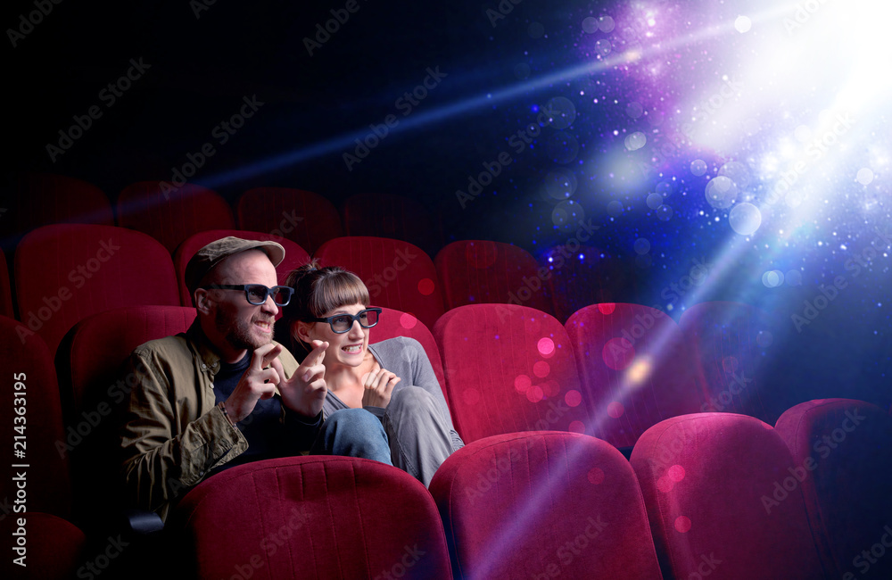 Obraz premium Romantic couple cuddling and watching the miraculous part of the film