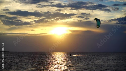	Kite boarding. Slow motion.	Sunset over the sea.