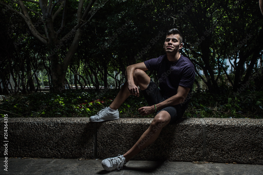 Obraz premium portrait of attractive young man sitting on a step