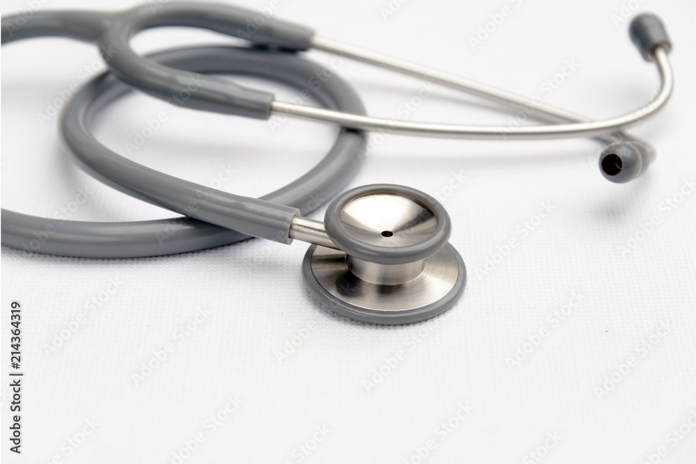 Gray stethoscope medical equipment on white canvas. instruments device for doctor. medicine concept Gray stethoscope medical equipment on white canvas. instruments device for doctor. medicine concept