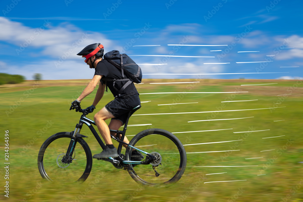 Fototapeta premium Casual hipster cyclist riding bicycle with high speed concept