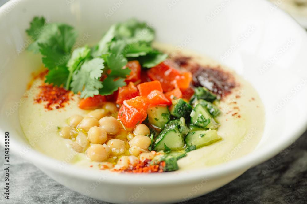 Hummus with vegetables, herbs, spices and cakes