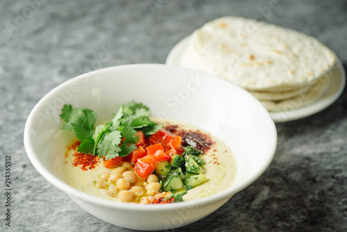 Hummus with vegetables, herbs, spices and cakes