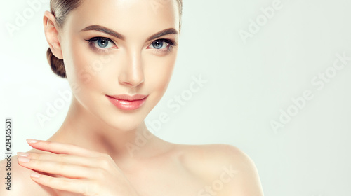 Beautiful Young Woman with Clean Fresh Skin look away .Girl beauty face care. Facial treatment . Cosmetology , beauty and spa . 
